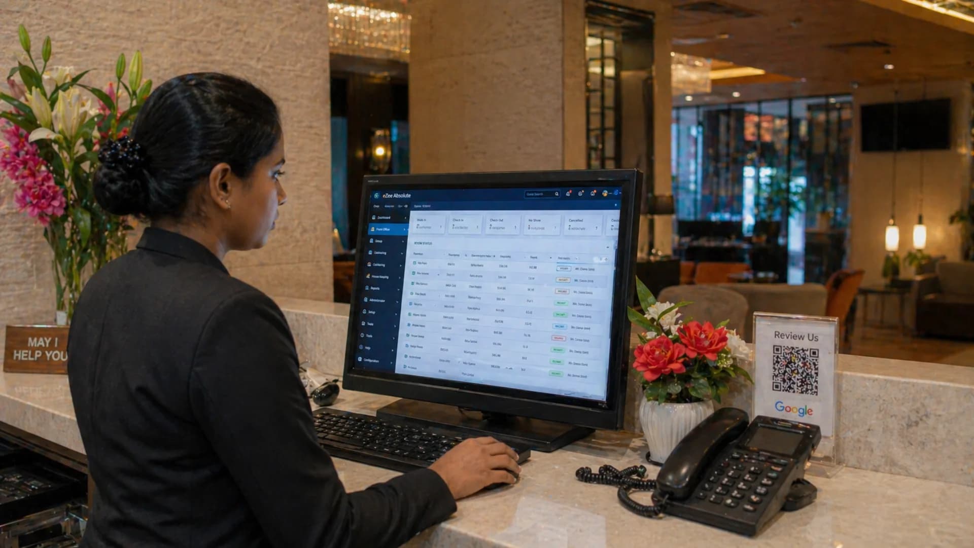 Best hotel management software India 2026 — Indian hotel front desk staff managing reservations on PMS dashboard