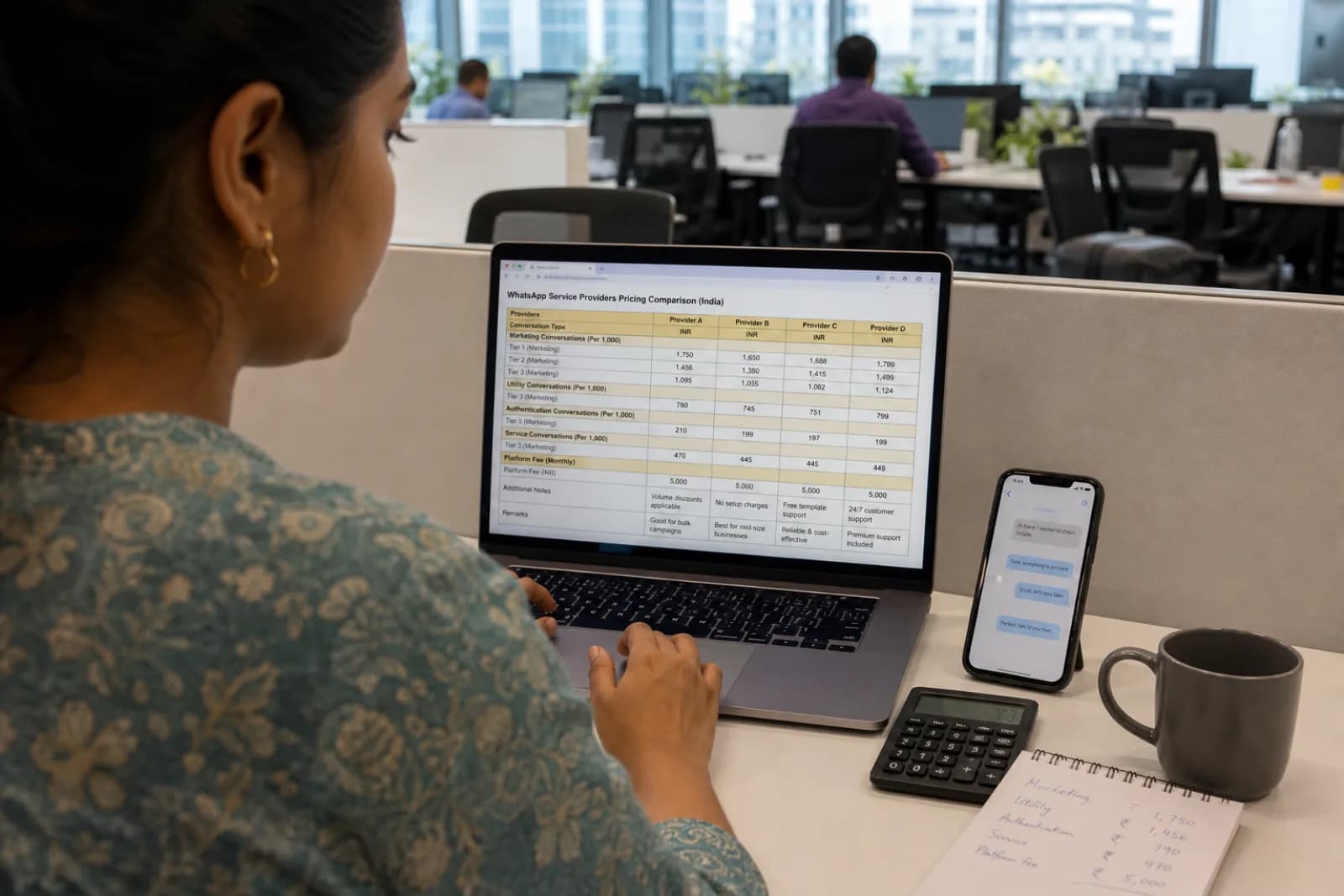 Indian marketing team comparing WhatsApp Business API pricing across WATI, Interakt, AiSensy, and Gupshup on a laptop