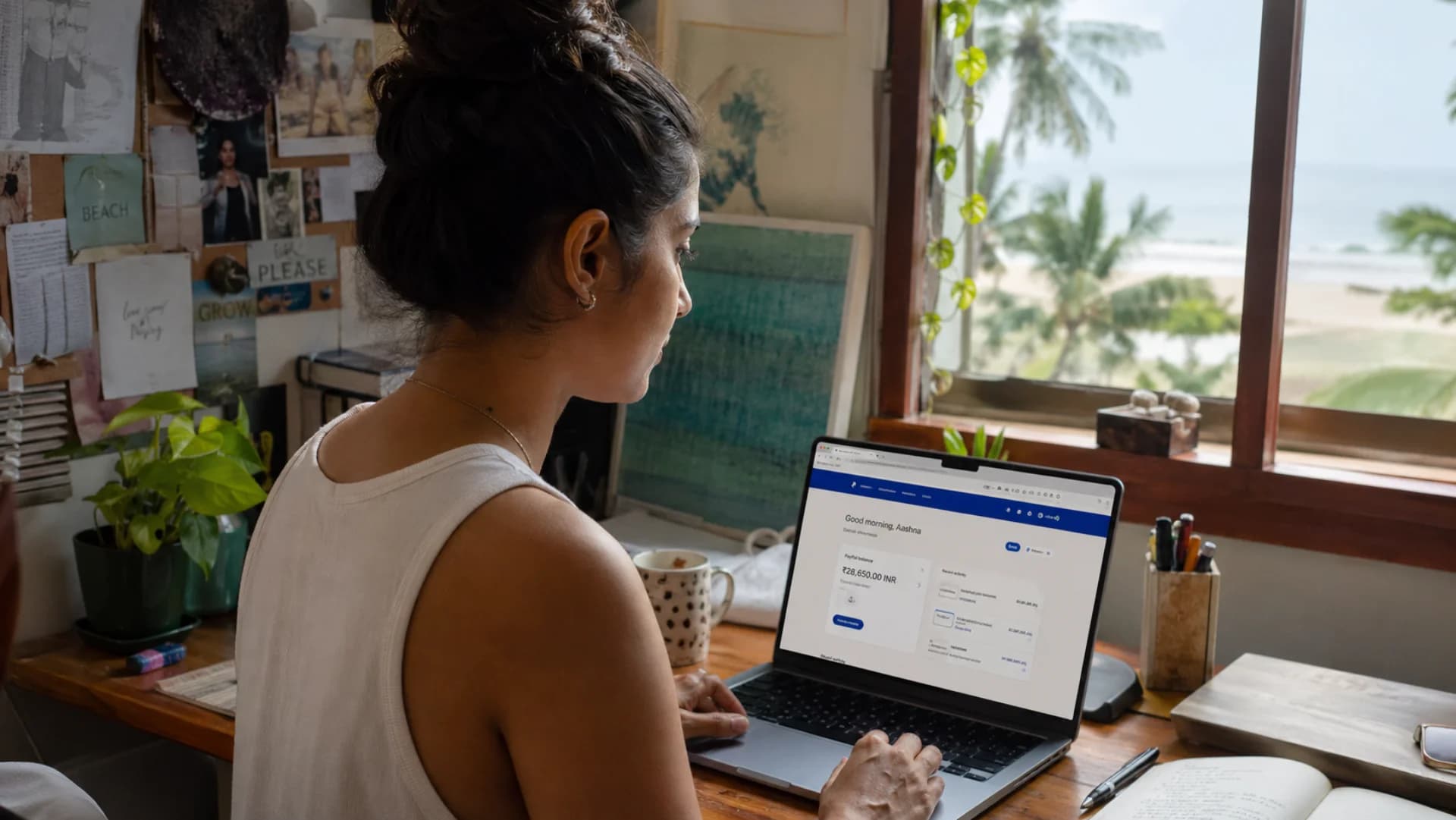 PayPal integration for cross-border e-commerce — freelance designer reviewing PayPal payouts on laptop in Goa home office